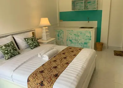 a bedroom with a large bed with a blue cabinet at NIKINIKO Beach House by Lolavillas - 100mts to the beach in Canggu