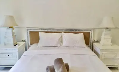 a bedroom with a bed with a pair of shoes on it at NIKINIKO Beach House by Lolavillas - 100mts to the beach in Canggu