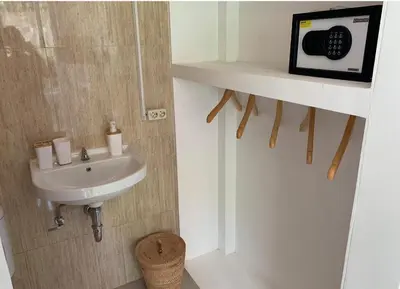 a bathroom with a sink and a microwave on a wall at NIKINIKO Beach House by Lolavillas - 100mts to the beach in Canggu