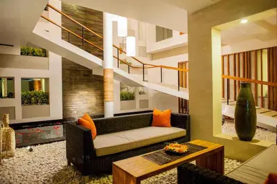 a living room with a couch and a staircase at Villa Muse Seminyak - 500 meters from beach in Seminyak