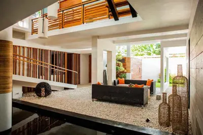 a living room with a couch and a fireplace at Villa Muse Seminyak - 500 meters from beach in Seminyak
