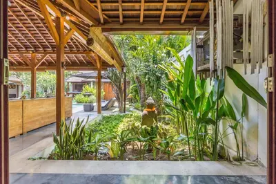an open courtyard with plants and a building at Tropical 5BR Villa & 20m Pool, Sleeps 12 in Seminyak