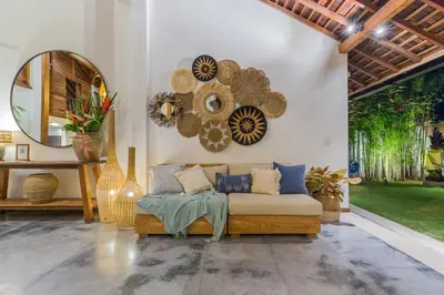a living room with a couch and a mirror at Tropical 5BR Villa & 20m Pool, Sleeps 12 in Seminyak