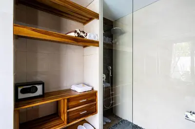 a bathroom with a shower and a sink at The Calna Villa Bali in Kuta