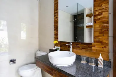 a bathroom with a sink and a toilet at The Calna Villa Bali in Kuta