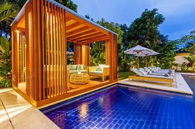 a swimming pool with a gazebo next to a house at THE BOTANICAL 6 BED LUXURY 900 meter from beach in Seminyak