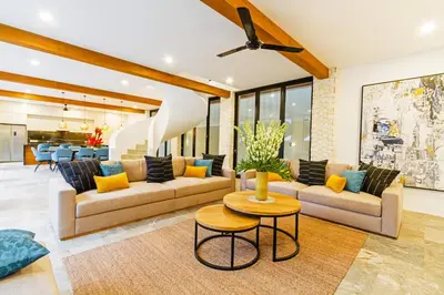 a living room with two couches and a table at THE BOTANICAL 6 BED LUXURY 900 meter from beach in Seminyak