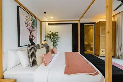 a bedroom with a large white bed with pillows at THE BOTANICAL 6 BED LUXURY 900 meter from beach in Seminyak