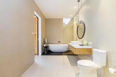 a bathroom with a tub and a toilet and a sink at THE BOTANICAL 6 BED LUXURY 900 meter from beach in Seminyak