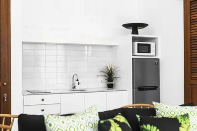 a kitchen with a sink and a refrigerator at Villa Alfie in Seminyak