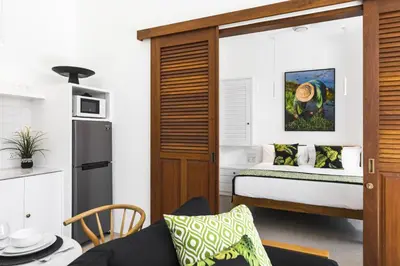 a small room with a bed and a kitchen at Villa Alfie in Seminyak