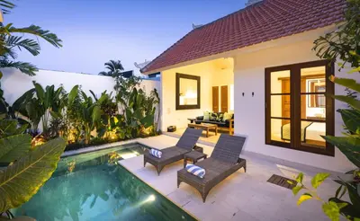 a villa with a swimming pool and a house at Villa Alfie in Seminyak