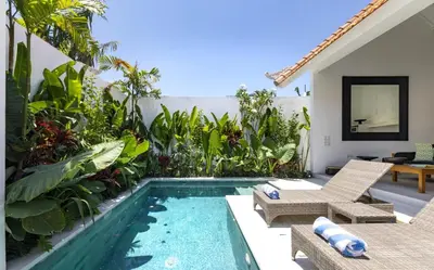 a backyard with a swimming pool and a villa at Villa Alfie in Seminyak