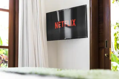 a television on a wall with the netflix sign at Villa Alfie in Seminyak