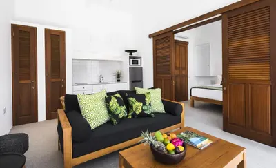 a living room with a couch and a bowl of fruit on a table at Villa Alfie in Seminyak