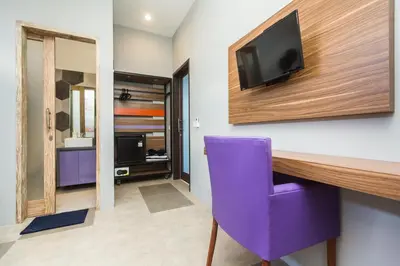 a room with a desk and a purple chair at 7Rooms Villa Seminyak in Seminyak