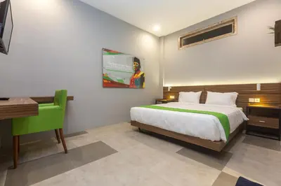 a bedroom with a bed and a desk and a computer at 7Rooms Villa Seminyak in Seminyak