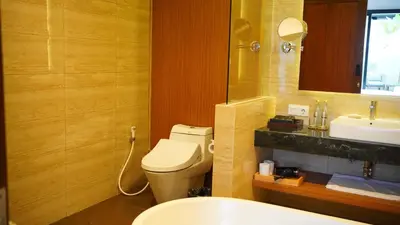 a bathroom with a toilet and a sink at The Claremont Luxury Villas in Seminyak