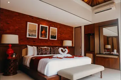 a bedroom with a bed with a bow on it at Sampatti Villas in Seminyak