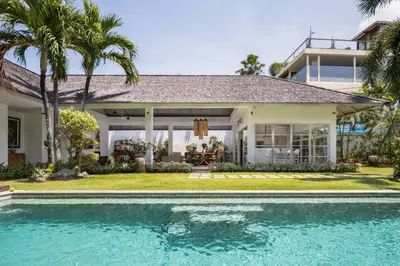 a house with a swimming pool in front of a house at 2BR Private Villa Seminyak, Villa Kiran One in Seminyak
