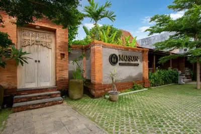 a house with a sign on the side of it at Moson Villa Legian in Legian