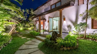 a house with a walkway in front of it at Villa Litera Canggu Bali in Canggu