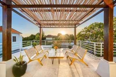 a patio with a table and chairs on a balcony at Villa Milano - Private 6 BDR Villa in Seminyak, prime Location, Pool & Garden in Canggu