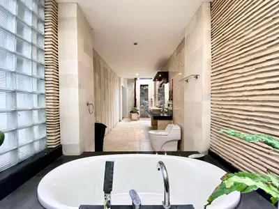 a bathroom with a bath tub and a sink at Harmony Villa Dua in Seminyak