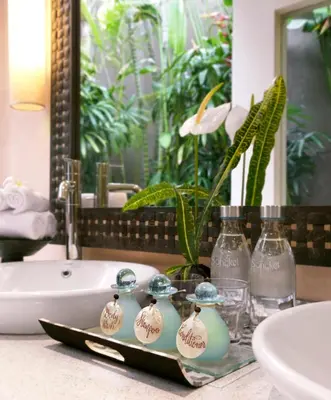 a bathroom with a sink and a bath tub at Villa Songket in Kerobokan