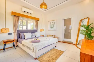 a bedroom with a bed and a mirror at Villa Florence - 3BDR Luxury Villa, Private Pool, Walk to the Beach in Seminyak