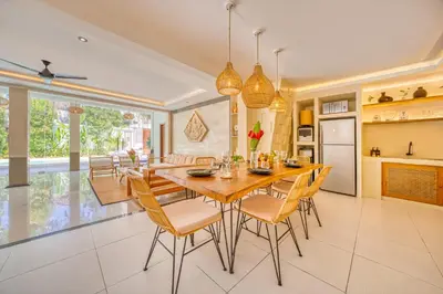 a kitchen and dining room with a wooden table and chairs at Villa Florence - 3BDR Luxury Villa, Private Pool, Walk to the Beach in Seminyak