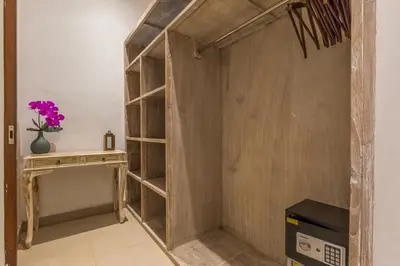 a book shelf in a room with a desk at Villa Bunga 1 in Seminyak