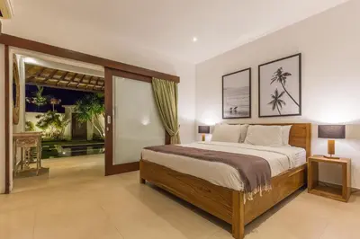 a bedroom with a large bed in a room at Villa Bunga 1 in Seminyak