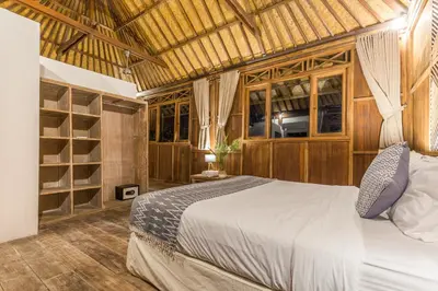 a bedroom with a bed and some shelves at Villa Bunga 1 in Seminyak