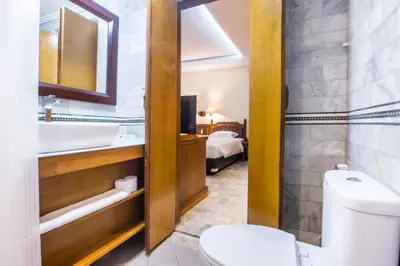 a bathroom with a toilet and a sink at Bali Bungalo Hotel in Kuta