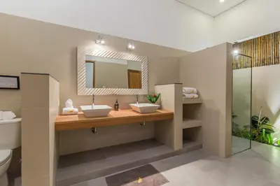 a bathroom with two sinks and a mirror at Pulesari 2 bedrooms in Seminyak