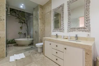 a bathroom with a sink and a tub and a toilet at Villa Lansel in Seminyak