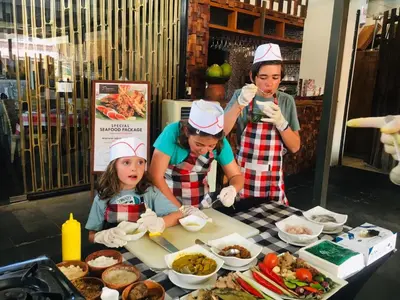 a group of people standing around a table with food at The Haere Seminyak - By Astadala in Seminyak
