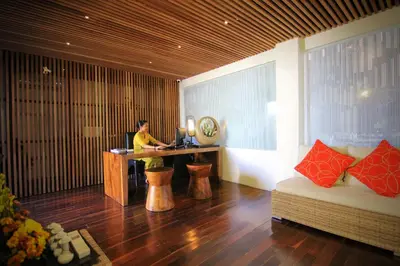 a woman sitting at a desk in a room at The Haere Seminyak - By Astadala in Seminyak