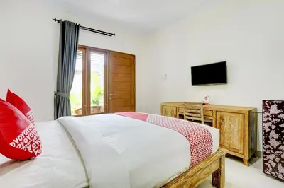 a bedroom with a large bed and a television at Hotel O March 67 Stay in Balian