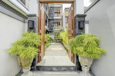 a hallway with potted plants in a building at Hotel O March 67 Stay in Balian