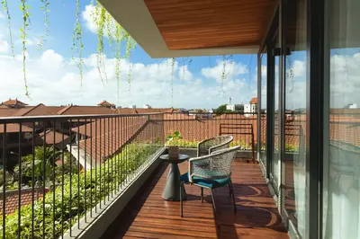a balcony with a table and chairs and a view at Beachwalk Residence in Kuta