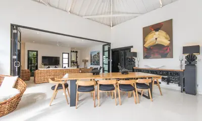 a dining room with a wooden table and chairs at Villa Lora in Seminyak