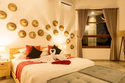 a bedroom with a bed with a dress on it at Cascata Villa Canggu in Canggu