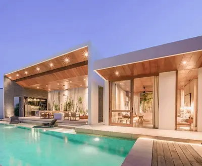 a house with a swimming pool in front of it at Villa Boya - 6BR luxury oasis in Central Berawa in Canggu