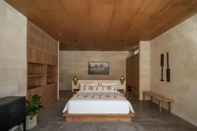 a bedroom with a large bed and a wooden ceiling at Villa Boya - 6BR luxury oasis in Central Berawa in Canggu