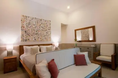a bedroom with a bed and a chair in it at 2BR Villa Violetta - Minggu Villas - Special Stay Bonus in Kerobokan