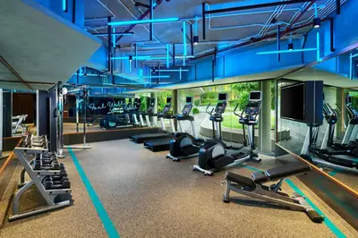 a gym with a bunch of treadmills and machines at Aloft Bali Kuta at Beachwalk in Kuta