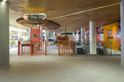 a shopping mall with a sign hanging from the ceiling at YELLO Hotel Kuta Beachwalk Bali in Kuta