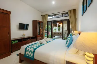 a bedroom with a large bed and a television at Villa Penny, Seminyak - Spacious 3 Bedroom Pool Villa! in Seminyak